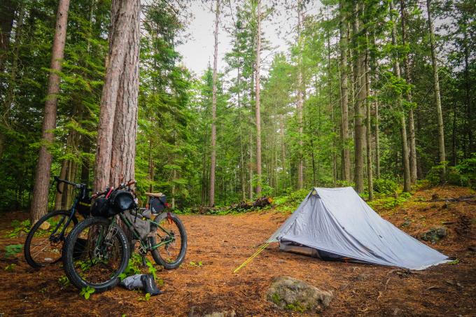 A bicycle is shown next to a tent.